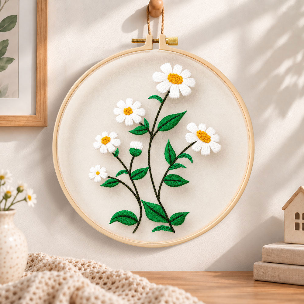 White daisies with green leaves embroidery hoop wall art displayed as warm and cozy handmade home decor