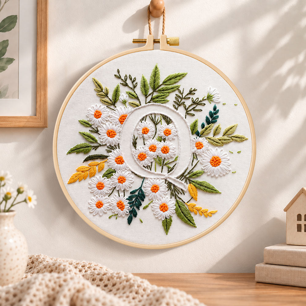 White daisy cluster and letter q embroidery hoop wall art displayed as warm and cosy handmade home decor