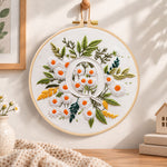 White daisy cluster and letter q embroidery hoop wall art displayed as warm and cosy handmade home decor