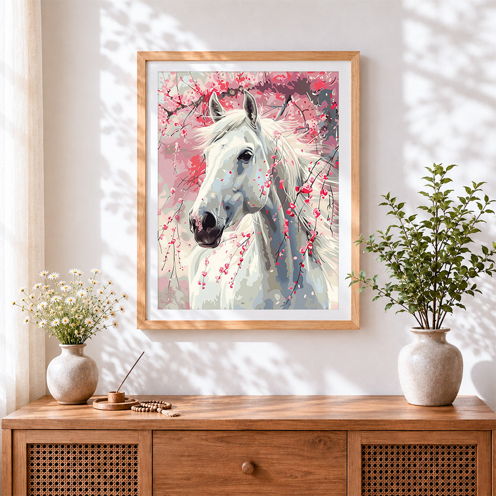 Finished white horse and cherry blossom cross stitch artwork displayed