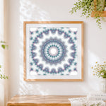 Finished white kaleidoscope mandala cross stitch artwork displayed