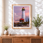 Finished white lighthouse under the pink and purple sky cross stitch artwork displayed