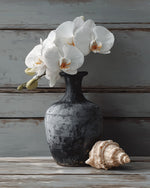 White orchids in a dark vase with shell cross stitch kit for beginners