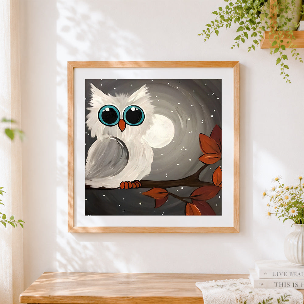 Finished white owl in moonlight cross stitch artwork displayed