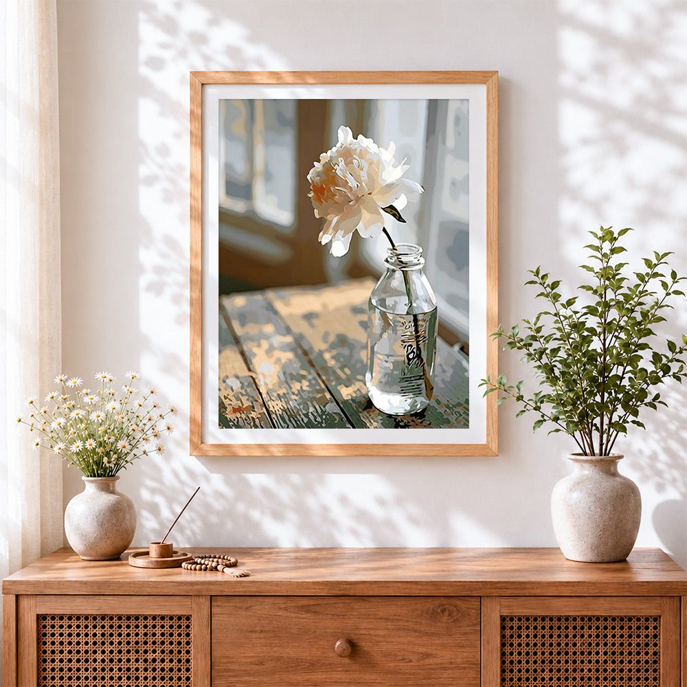 Finished white peony in glass bottle cross stitch artwork displayed