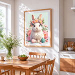 White rabbit with flower crown and easter eggs cross stitch artwork displayed on wall as home decor