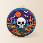 White skull with colourful mushroom trees needle felting kit for beginners with a round wooden frame