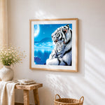 White tiger and cub under the moon cross stitch artwork displayed on wall as home decor