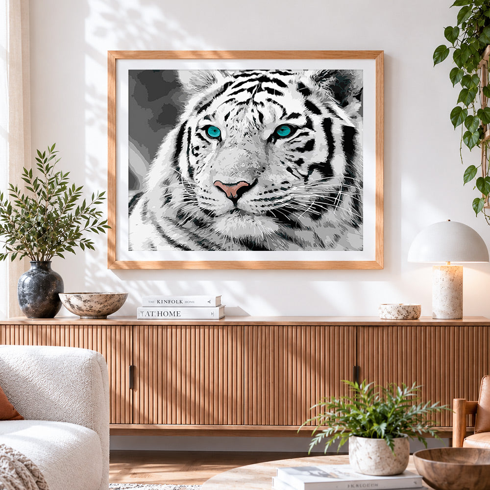 Finished white tiger with blue eyes cross stitch artwork displayed