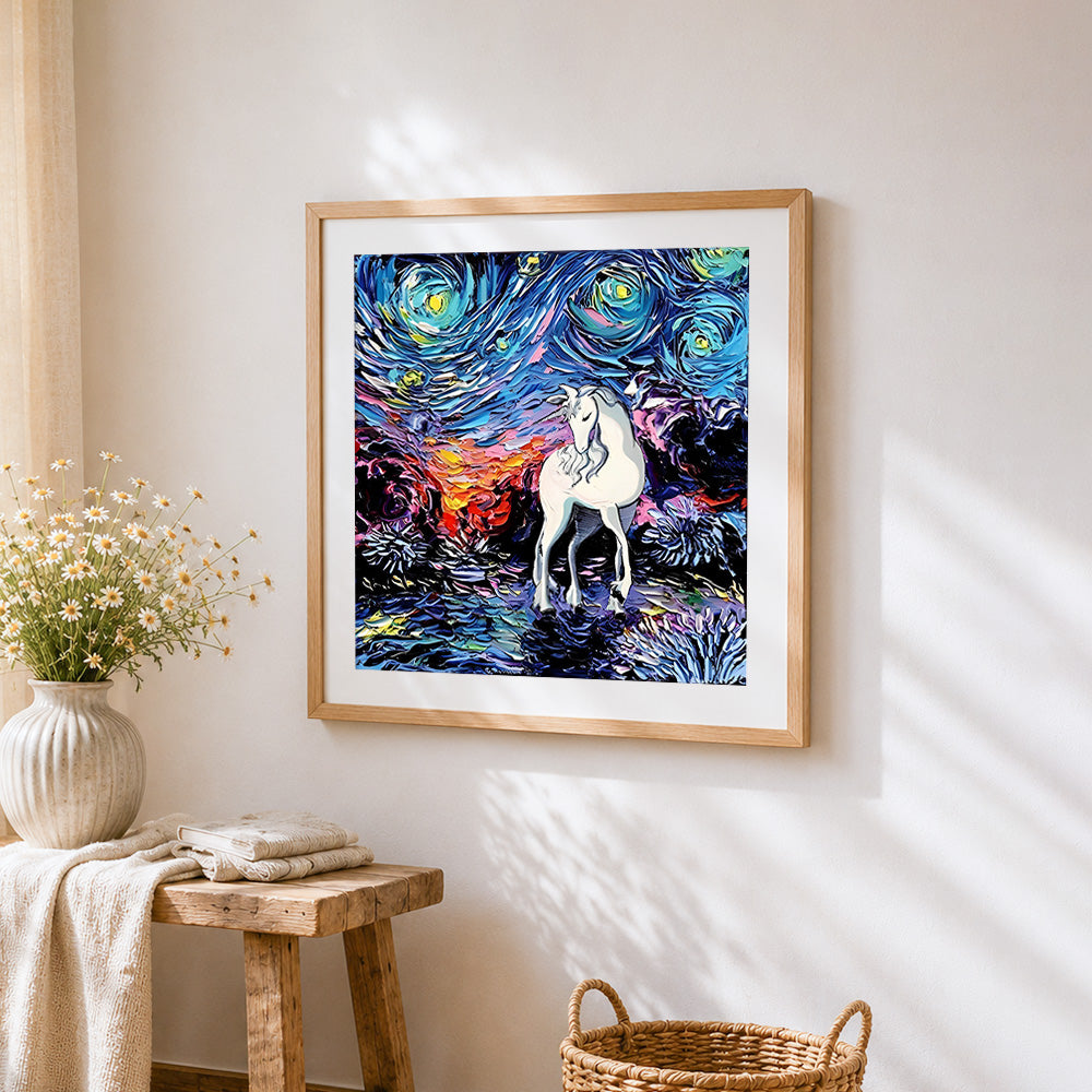 White unicorn in a starry night cross stitch artwork displayed on wall as home decor