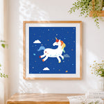 Finished white unicorn with colourful mane cross stitch artwork displayed