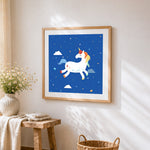 White unicorn with colourful mane cross stitch artwork displayed on wall as home decor