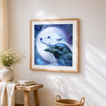White wolf and raven under a full moon cross stitch artwork displayed on wall as home decor