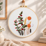 Wild berry and dandelion blooms embroidery hoop wall art displayed as warm and cosy handmade home decor