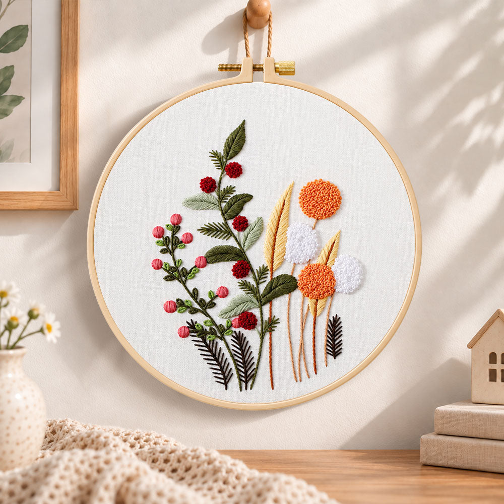 Wild berry and dandelion blooms embroidery hoop wall art displayed as warm and cosy handmade home decor