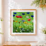 Finished wildflower meadow cross stitch artwork displayed