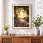 Finished willow tree framing a golden lake sunset cross stitch artwork displayed