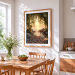 Willow tree framing a golden lake sunset cross stitch artwork displayed on wall as home decor