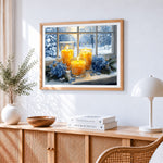 Window candles and snowy view cross stitch artwork displayed on wall as home decor