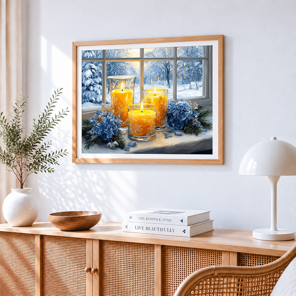 Window candles and snowy view cross stitch artwork displayed on wall as home decor