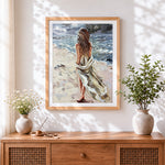 Finished windswept woman on beach cross stitch artwork displayed