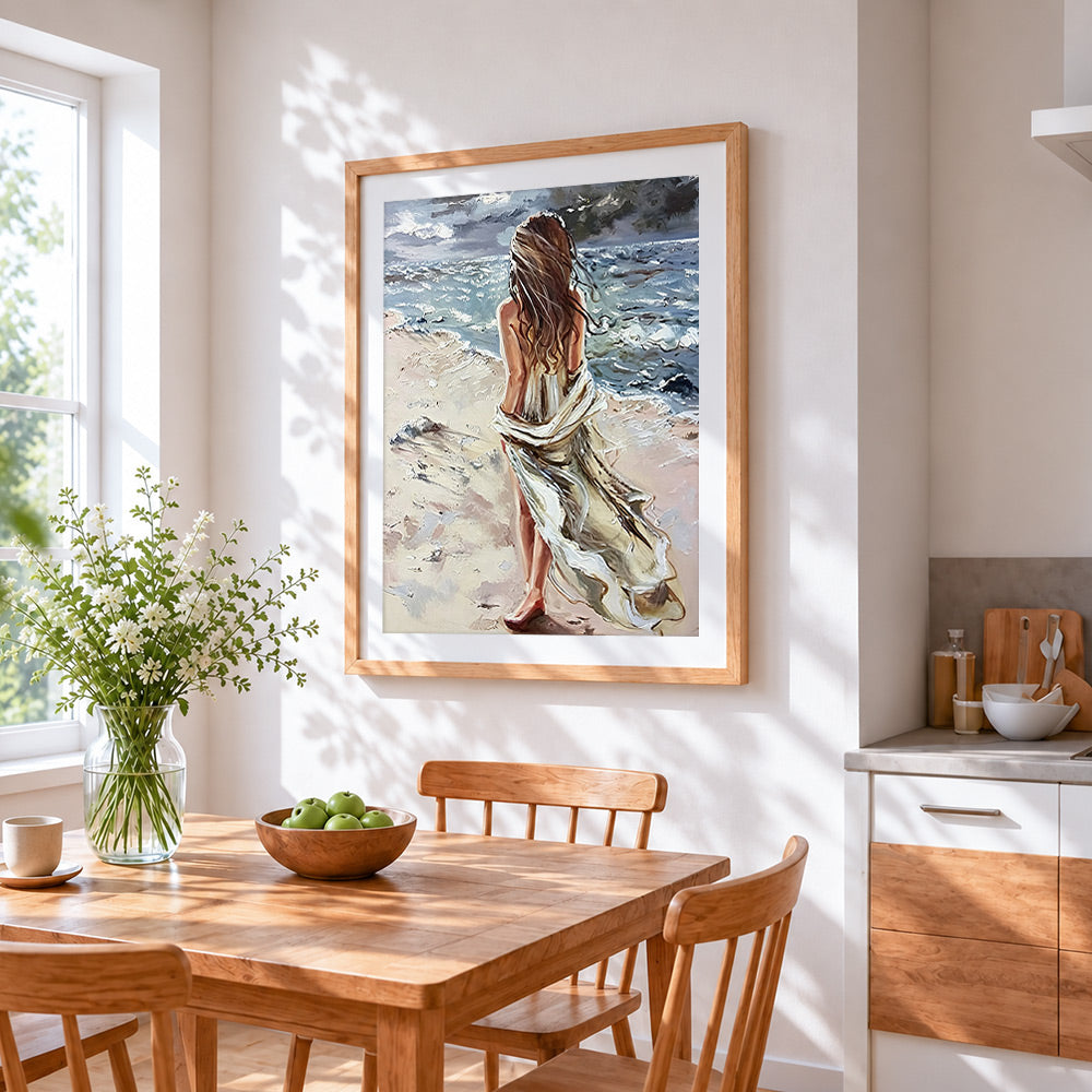 Windswept woman on beach cross stitch artwork displayed on wall as home decor