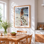 Windswept woman on beach cross stitch artwork displayed on wall as home decor