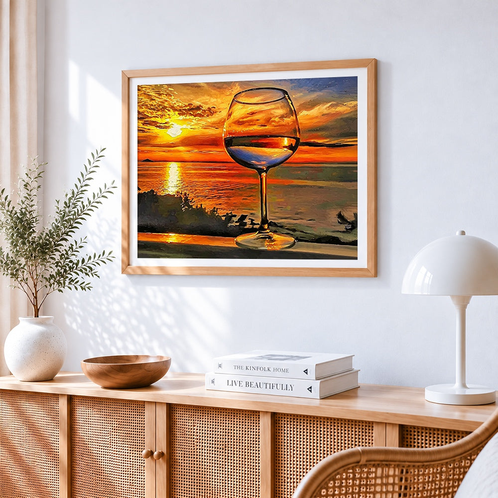 Wine glass by the sea at sunset cross stitch artwork displayed on wall as home decor