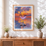 Finished wine glass reflecting sunset clouds cross stitch artwork displayed