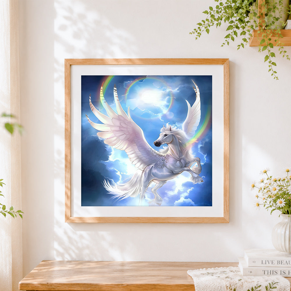 Finished winged unicorn flying through rainbow clouds cross stitch artwork displayed