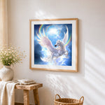 Winged unicorn flying through rainbow clouds cross stitch artwork displayed on wall as home decor