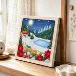 Winter mountain landscape punch needle artwork displayed on a table