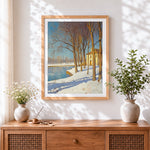 Finished winter riverside cottage cross stitch artwork displayed