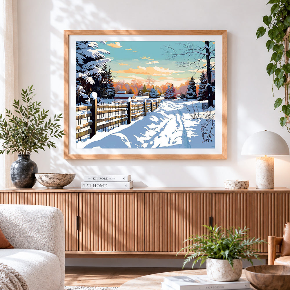 Finished winter sunset and snowy cabin cross stitch artwork displayed
