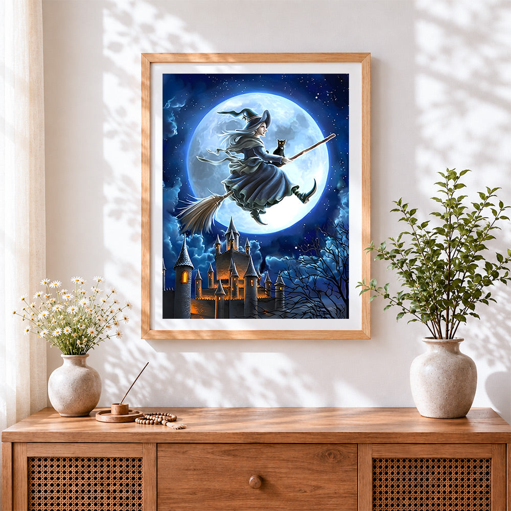 Finished witch and black cat flying over a castle cross stitch artwork displayed
