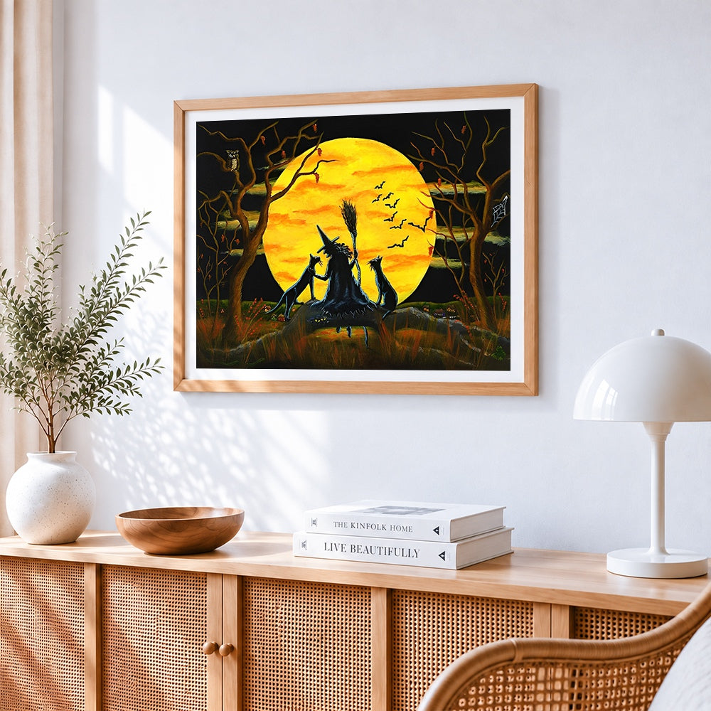 Witch and black cats silhouette cross stitch artwork displayed on wall as home decor