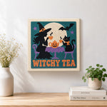 Finished witch and cat having tea artwork displayed on a wall