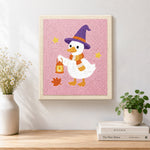 Finished witch duck holding lantern artwork displayed on a wall