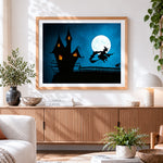 Finished witch flying over a haunted house cross stitch artwork displayed