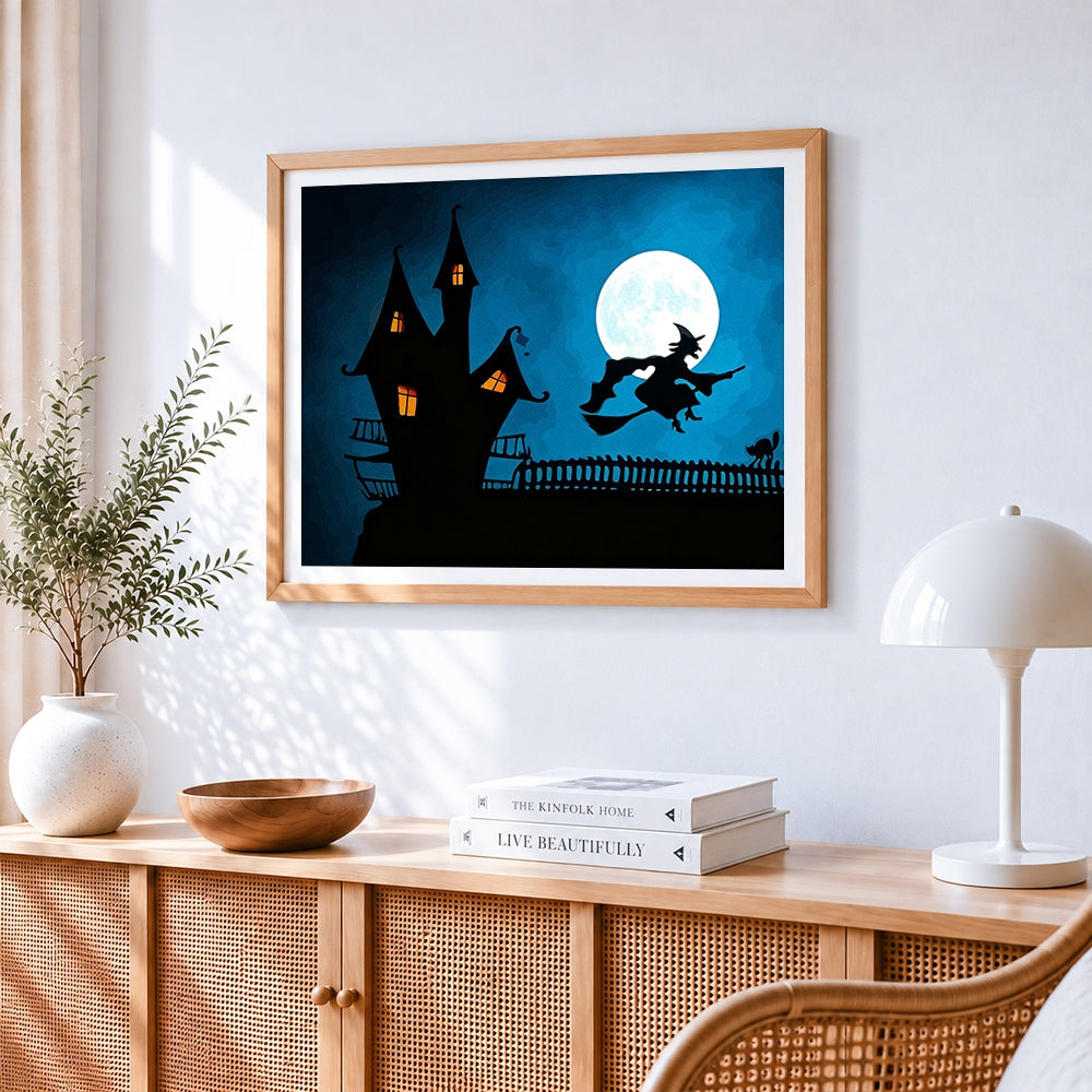 Witch flying over a haunted house cross stitch artwork displayed on wall as home decor