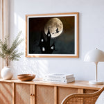 Witch flying past a full moon and spooky castle cross stitch artwork displayed on wall as home decor