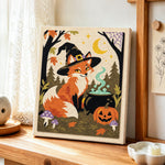Witch fox with magic cauldron punch needle artwork displayed on a table