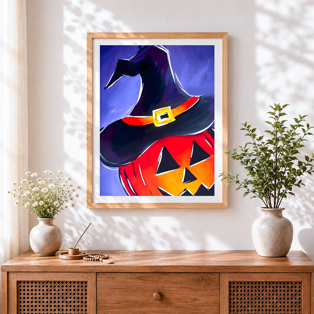 Finished witch hat on glowing pumpkin cross stitch artwork displayed
