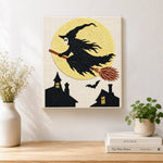 Finished witch silhouette against full moon artwork displayed on a wall