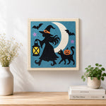 Finished witch silhouette under moon artwork displayed on a wall