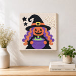 Finished witch with magic cauldron artwork displayed on a wall