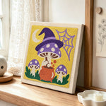 Witchy mushrooms punch needle artwork displayed on a table