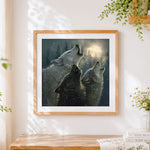 Finished wolves howling in a snowy forest cross stitch artwork displayed