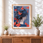 Finished woman and crimson butterflies cross stitch artwork displayed