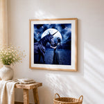 Woman and dark unicorn under a full moon cross stitch artwork displayed on wall as home decor